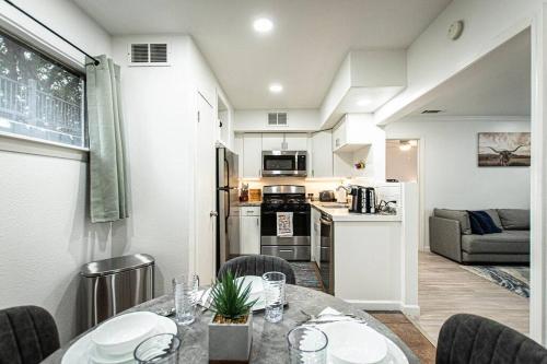 a kitchen and living room with a table and chairs at Downtown Austin Suite Retreat in Austin