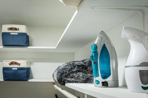a room with a shelf with a sewing machine on it at Downtown Austin Suite Retreat in Austin