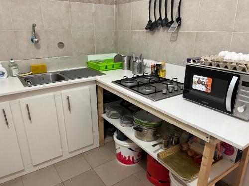 a kitchen with a sink and a stove top oven at Residence B&B Hibiscus in Dakar