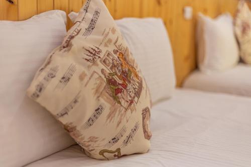 a pillow sitting on top of a bed at Yishin Garden B&B in Pinghe
