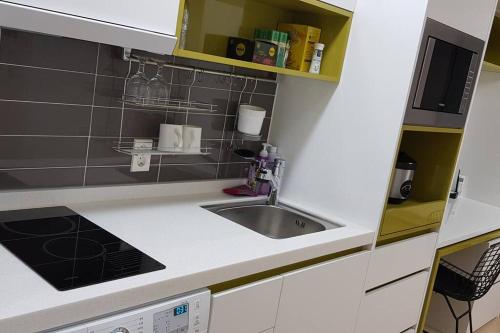 a kitchen with a sink and a counter top at Ocean Cloud - Long term Stay in Seogwipo