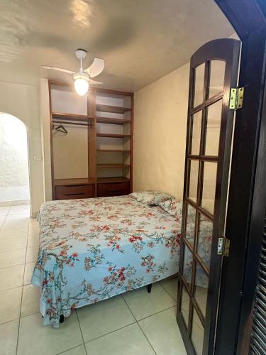 a bedroom with a bed and a wooden ladder at Tenório Beach Hostel 400 MTS da praia do Tenório in Ubatuba