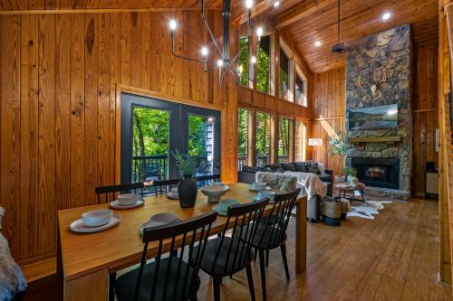 a dining room and living room with a table and chairs at Escape to Sugar Chalet: The Rustic Modern Retreat in Gatlinburg