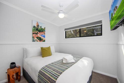 a bedroom with a white bed and a window at Ingenia Holidays Soldiers Point in Soldiers Point