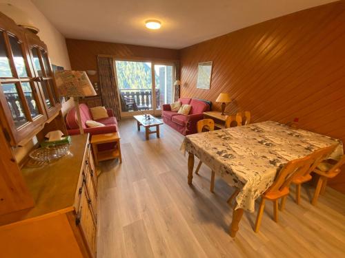 un salon avec une table et un canapé dans l'établissement Grand appart, à 500m du centre. Multi Pass été 2024 à 3€/jour! Parking couvert inclus. - FR-1-693-107, à Châtel