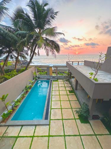 a swimming pool with a view of the ocean at Villa Sea Queen in Ambalangoda