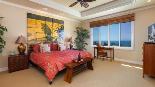 a bedroom with a large bed with a red bedspread at Beautiful Ocean Villa Beautiful Mauna Kea Home with Sunsets and Ocean Views in Hapuna Beach