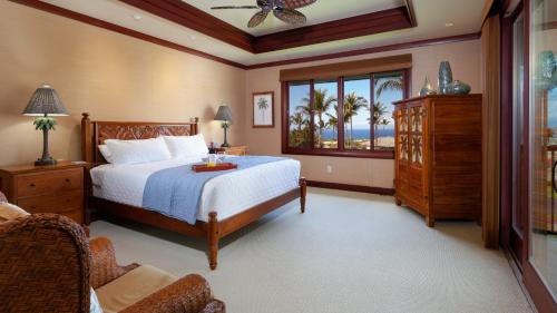 a bedroom with a bed and a large window at OCEAN PALSM VILLA Refined 3BR Waiulaula Home with Stunning Ocean Views in Hapuna Beach