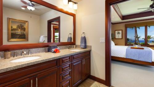 a bathroom with two sinks and a large mirror at OCEAN PALSM VILLA Refined 3BR Waiulaula Home with Stunning Ocean Views in Hapuna Beach
