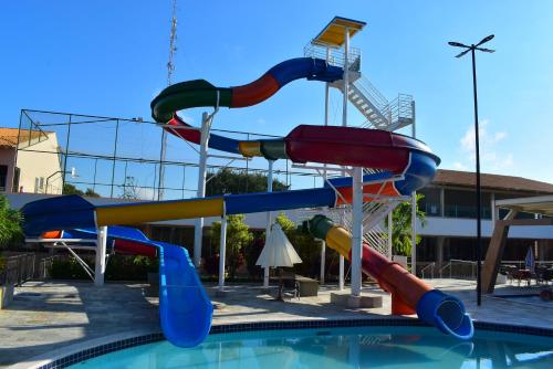 a water slide in a swimming pool at diRoma Fiori - Apartamentos JN in Caldas Novas