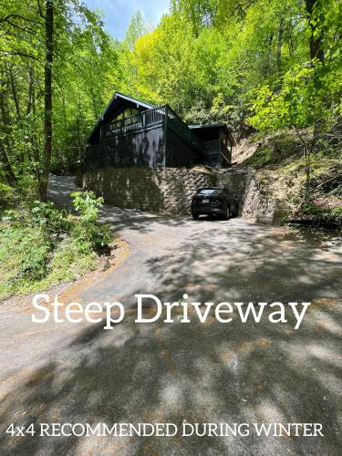 a car parked in front of a building on a road at Escape to Sugar Chalet: The Rustic Modern Retreat in Gatlinburg