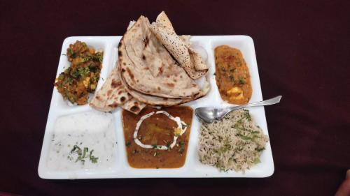 a plate of food with rice and different types of food at MS RESORT in Dalhousie