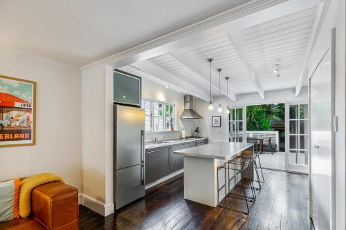 a kitchen with white walls and a white ceiling at Beautiful Ponsonby Villa by Zodiak Stays in Auckland