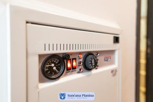 a gas pressure gauge on the side of a appliance at Sunčana Planina - Apartmani Wombat in Kopaonik
