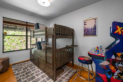 a childs room with a bunk bed and a table at Escape to Sugar Chalet: The Rustic Modern Retreat in Gatlinburg