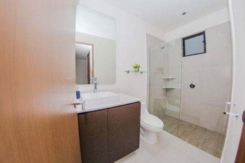 a bathroom with a sink and a toilet at Versalles Vista at Roma 240 in Puerto Vallarta