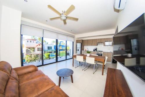 a living room with a couch and a ceiling fan at Versalles Vista at Roma 240 in Puerto Vallarta