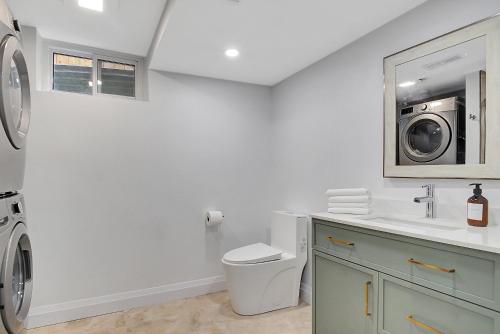 a bathroom with a sink and a washing machine at New Two Bedroom Apartment In Waterloo in Waterloo