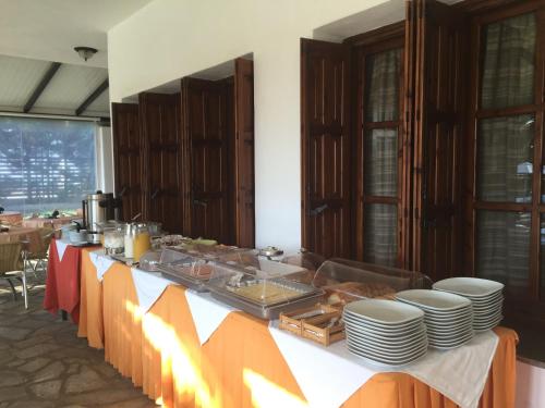 a long table with plates and food on it at Hotel Melikari in Skiros