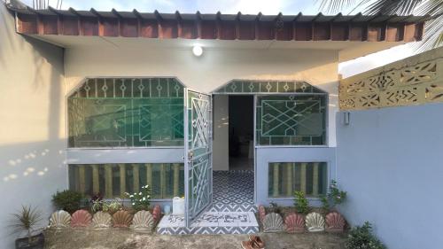a front door of a house with green glass at Studio ovangi bis in Libreville