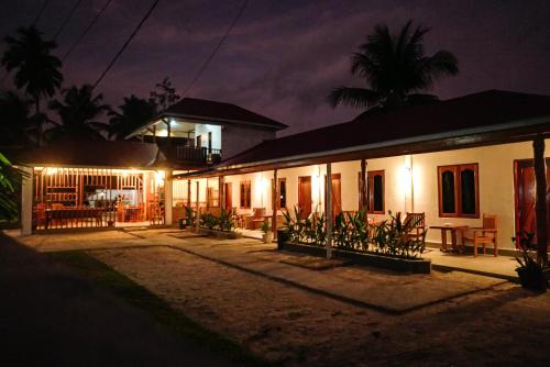 a house at night with lights in front of it at Suzi Beach House in Tua Pejat
