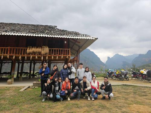 a group of people posing for a picture in front of a building at Tày Cốc Pảng Homestay in Làng Cac