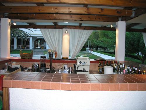 a bar with a tile counter top in a house at Hotel Melikari in Skiros