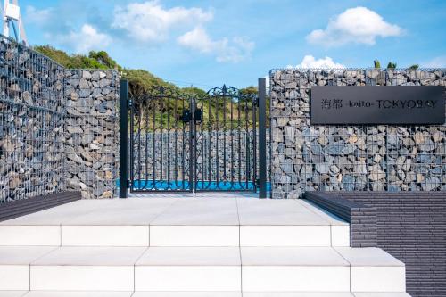 a gate to a stone wall with a sign at 海都-kaito- TOKYOBAY in Futtsu