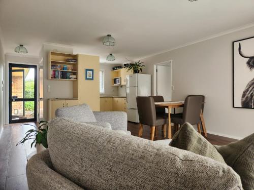 a living room with a couch and a table at Karapiro Apartment in Cambridge