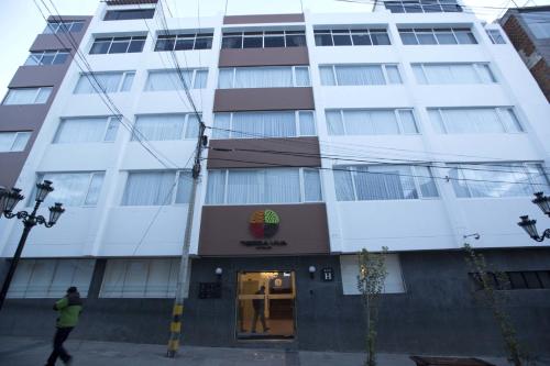 a man walks in front of a building at Tierra Viva Puno Plaza in Puno