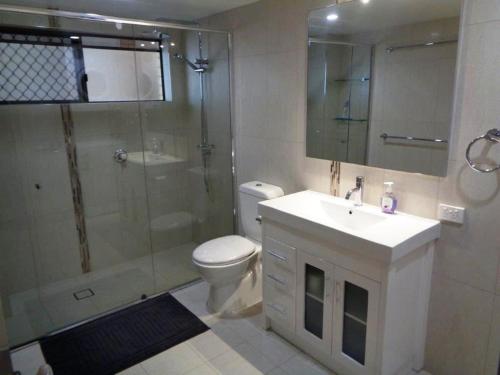 a bathroom with a shower and a toilet and a sink at Pacific Palms 3, Unit 3, 9-11 Terrace Street Evans Head in Evans Head