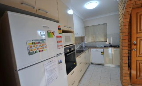 a kitchen with a white refrigerator and appliances at Pacific Palms 3, Unit 3, 9-11 Terrace Street Evans Head in Evans Head