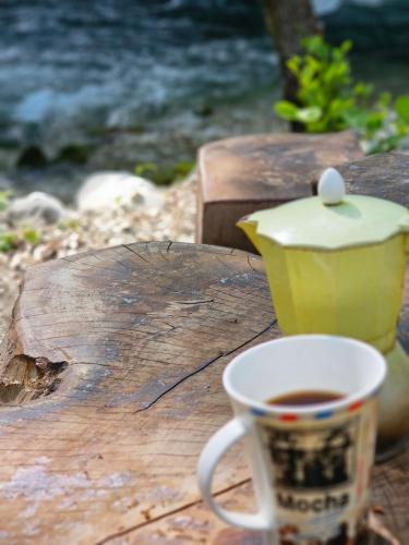a cup of coffee sitting on top of a wooden table at InSxvava in Ambrolauri
