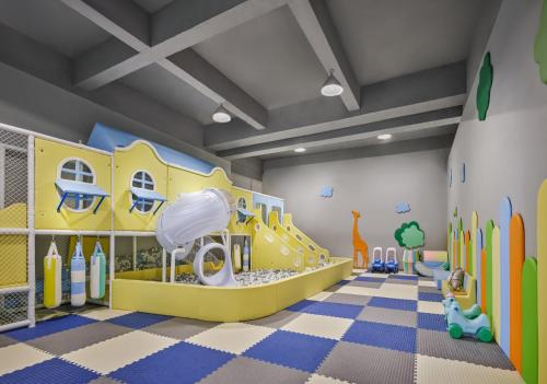 a childrens play room with a slide and snowboard at The Azure Ningbo, Vignette Collection in Ningbo
