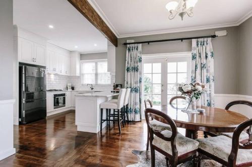 a kitchen with a table and chairs and a dining room at Byrne House - 3BR Rustic Luxe - Wi-Fi in Mount Gambier