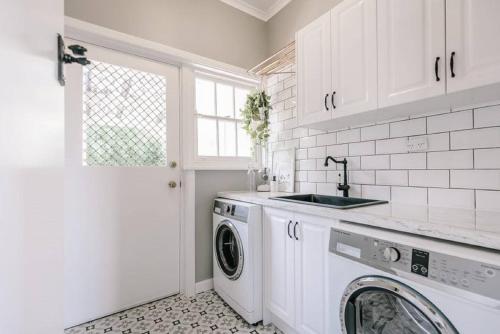 a white laundry room with a washer and a sink at Byrne House - 3BR Rustic Luxe - Wi-Fi in Mount Gambier