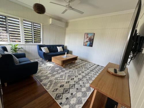 a living room with a couch and a table at 3 bed room house near airport in North Ward