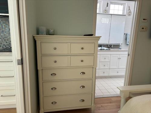 a dresser in a room with a kitchen at Oceanfront Adorable Cottage! Perfect For A Couple Or Small Family Of 4! in Ship Bottom