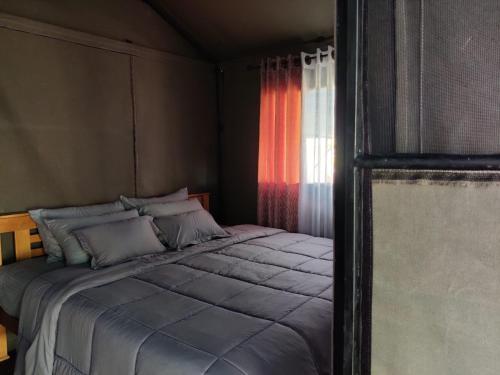 a bed in a room with a window at Harmony Haven, Udawalawe, Sri Lanka in Udawalawe