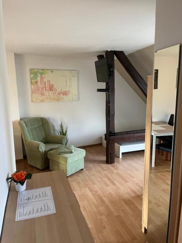 a living room with a couch and a stair case at Monteur-Pension W8 in Bad Schmiedeberg