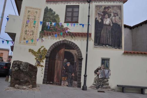 a church with paintings on the side of a building at Sulla via del Mare Room I.U.N R5045 in Terralba