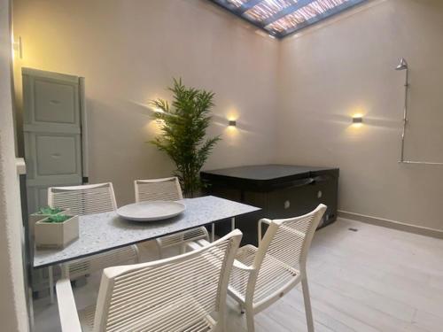 a dining room with a table and chairs and a window at Estia Luxury Apartment in Ierápetra