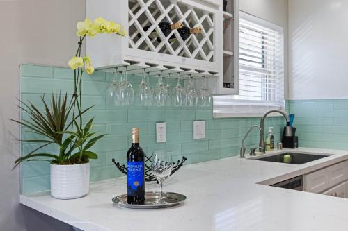 a kitchen counter with a bottle of wine and a wine glass at 5 Mins Walk To Oldtown Monrovia Cozy 4 Br Home in Monrovia