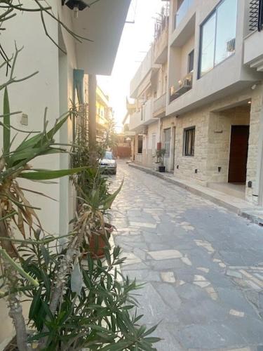 an empty street with a car parked on the side of a building at Estia Luxury Apartment in Ierápetra