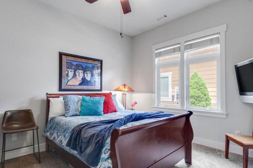 a bedroom with a bed with colorful pillows and a window at Elegant Boise River Home at Bown Crossing with Hot Tub in Boise