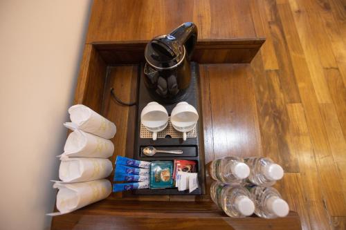 a wooden drawer with cups and other items on a floor at Hotel Grand Turf By GSP in Nuwara Eliya