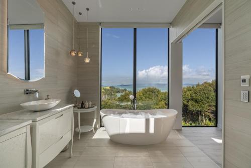 a bathroom with a large tub and two sinks at Omana in Rocky Bay