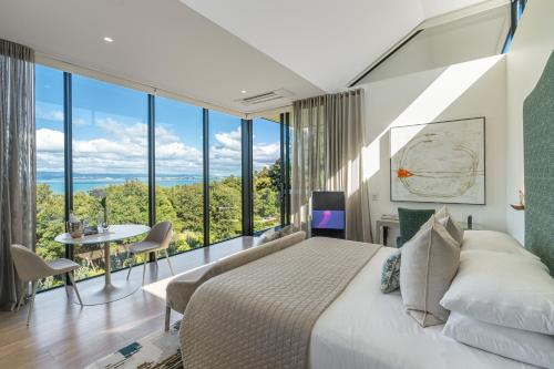 a bedroom with a bed and a large window at Omana Luxury Villa in Rocky Bay