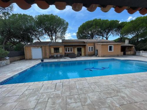 a villa with a swimming pool in front of a house at Villa in Vidauban with Pool and BBQ in Vidauban