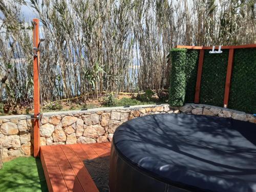 a backyard with a bed and a stone wall at Villa PANORAMA in Pag
